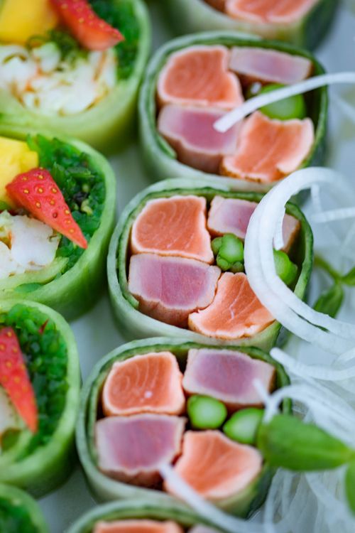 Fresh cucumber rolls with spicy tuna filling on a white plate