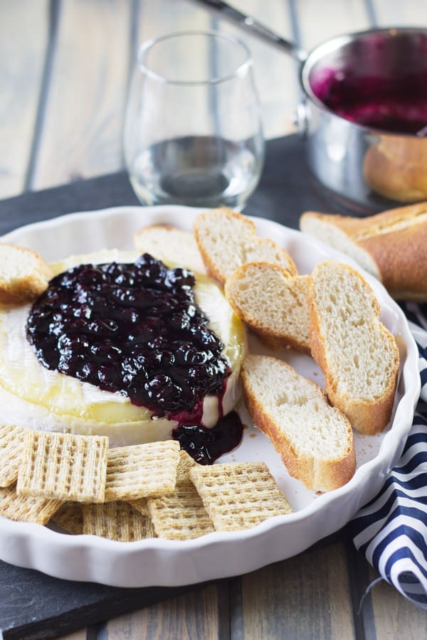 Blueberry baked brie with honey drizzle and crackers