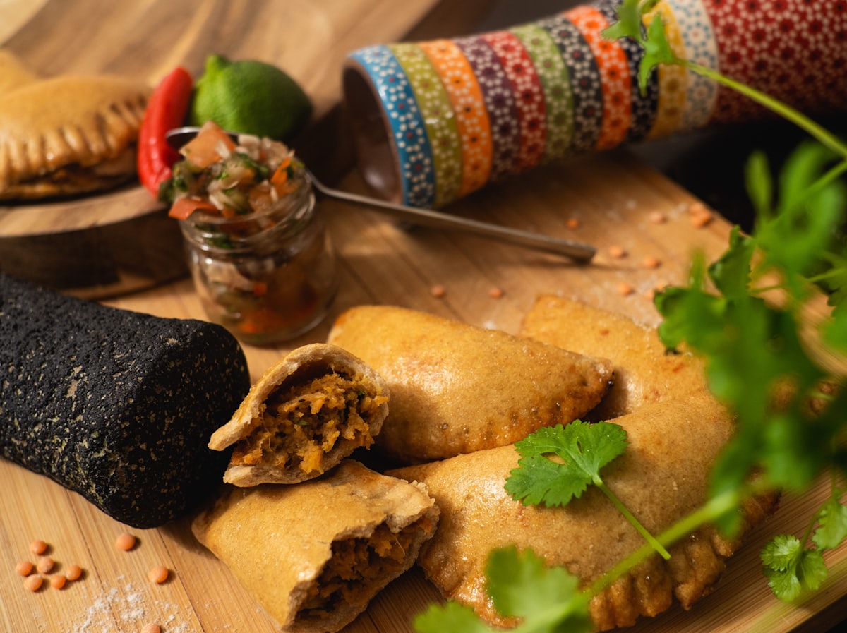 Golden homemade empanadas on a wooden board