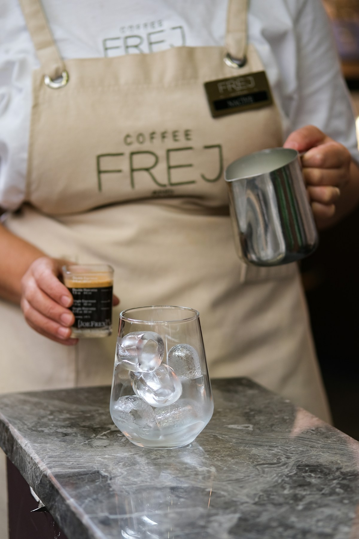 Iced espresso drink with lemon over ice in a tall glass