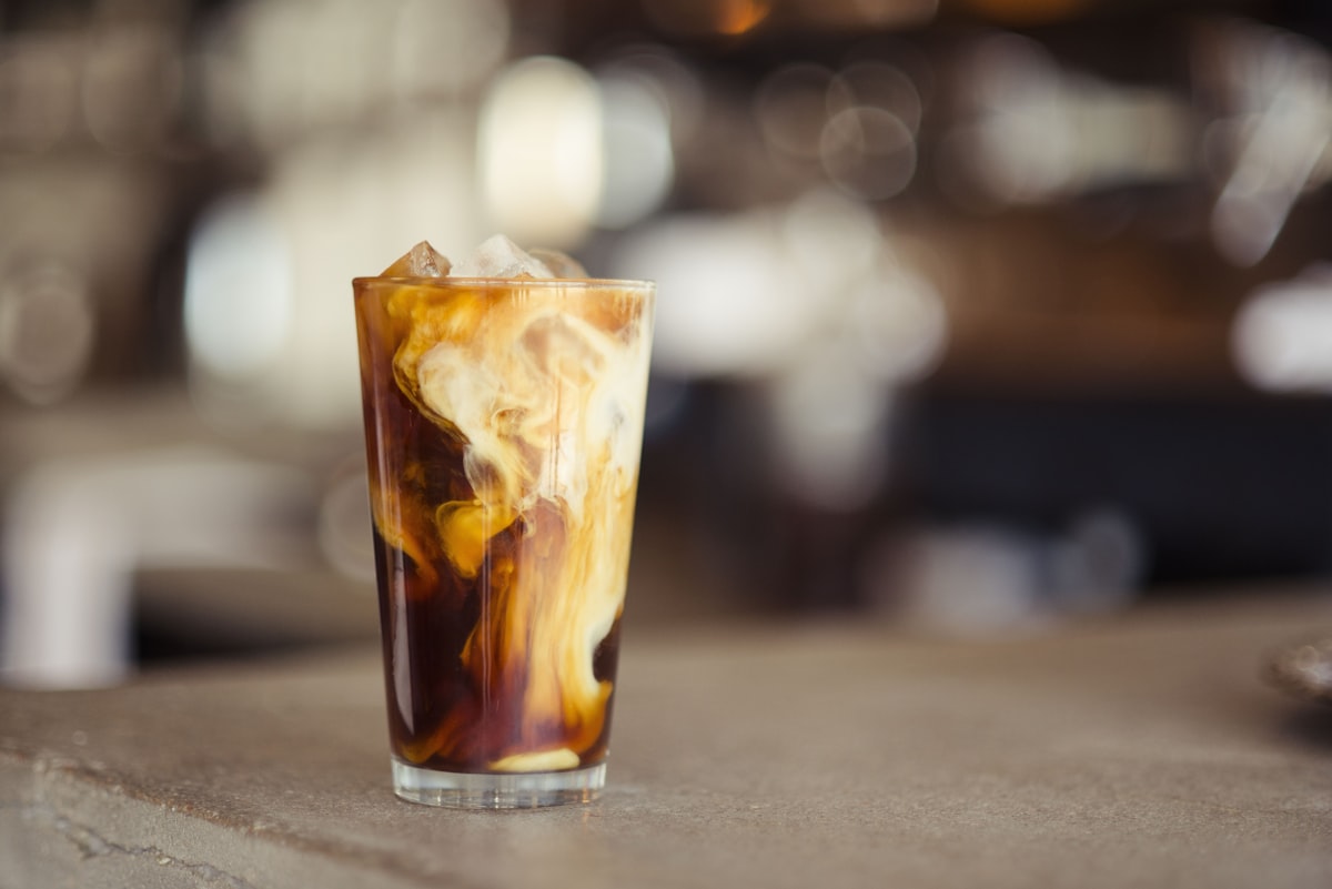 Frozen iced coffee slushie drink in a tall glass with ice