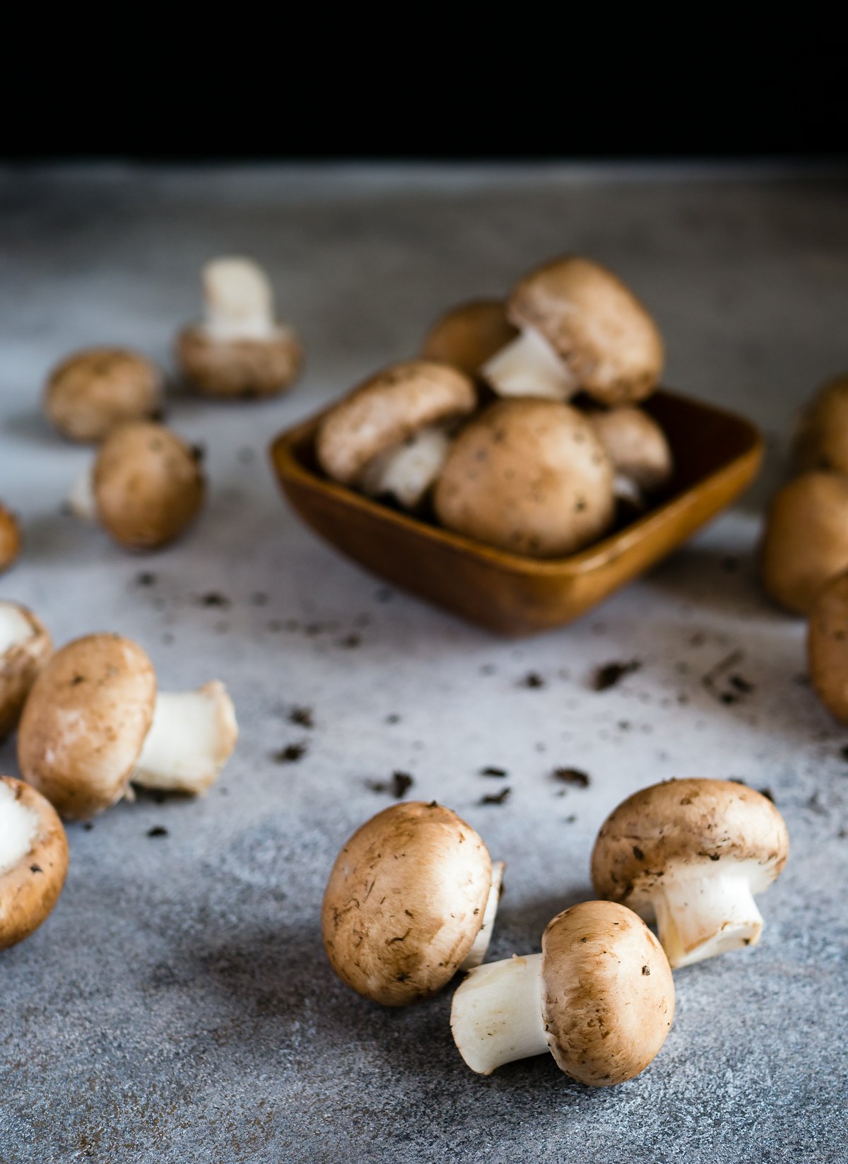 Fresh assorted mushrooms on a cutting board ready for cooking