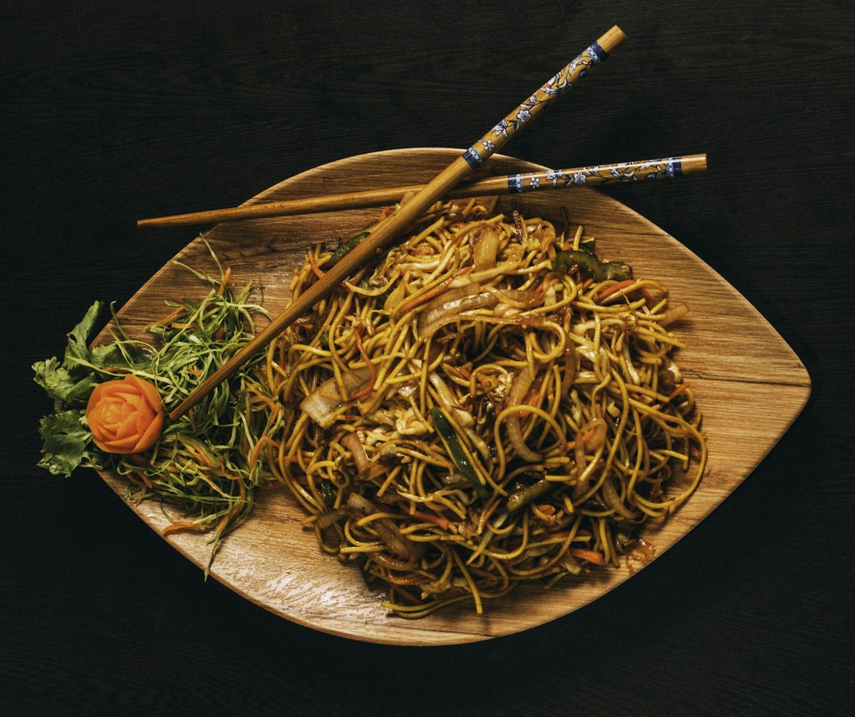Gochujang butter noodles in a bowl with scallions and sesame seeds