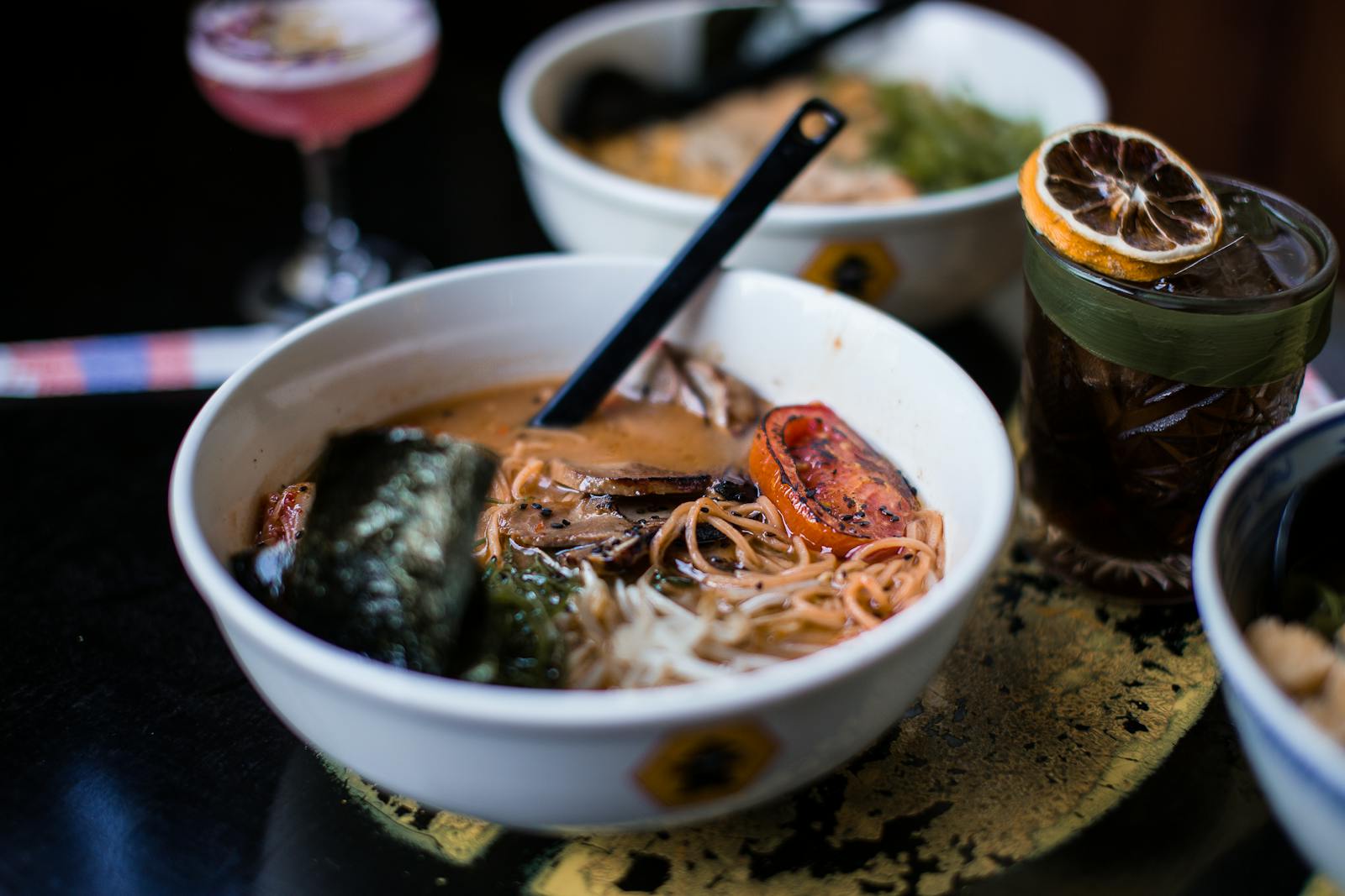 A gourmet ramen bowl with soft-boiled egg, nori, and chili crisp