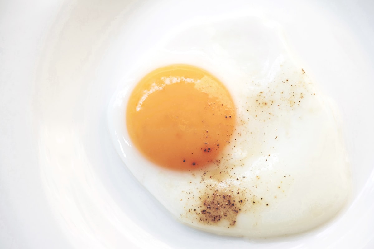 A perfectly cooked sunny-side-up egg with a runny golden yolk