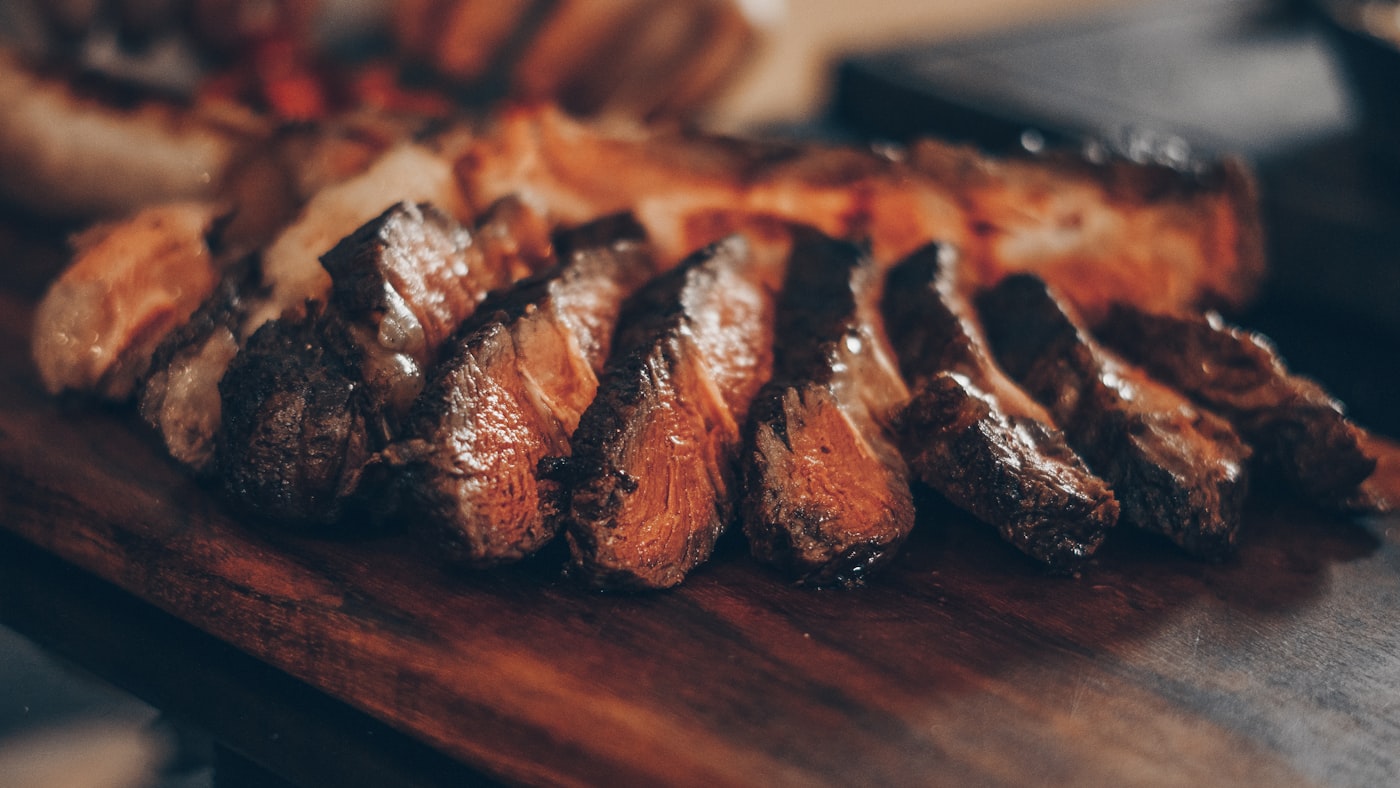Grilled meats and sides spread out on a cookout table