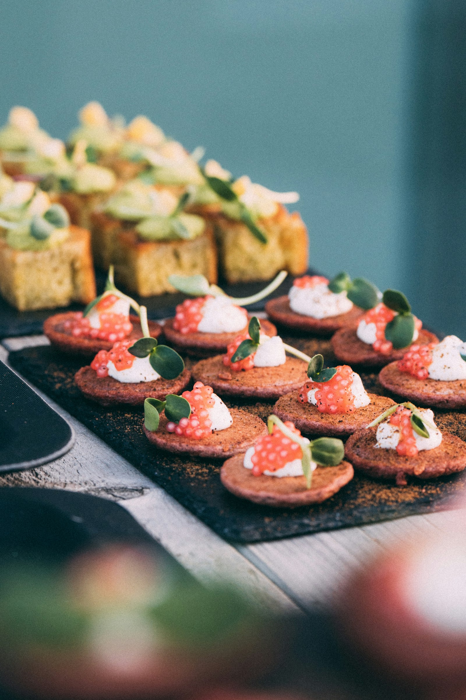Elegant bite-sized canapés and mini appetizers on a serving board