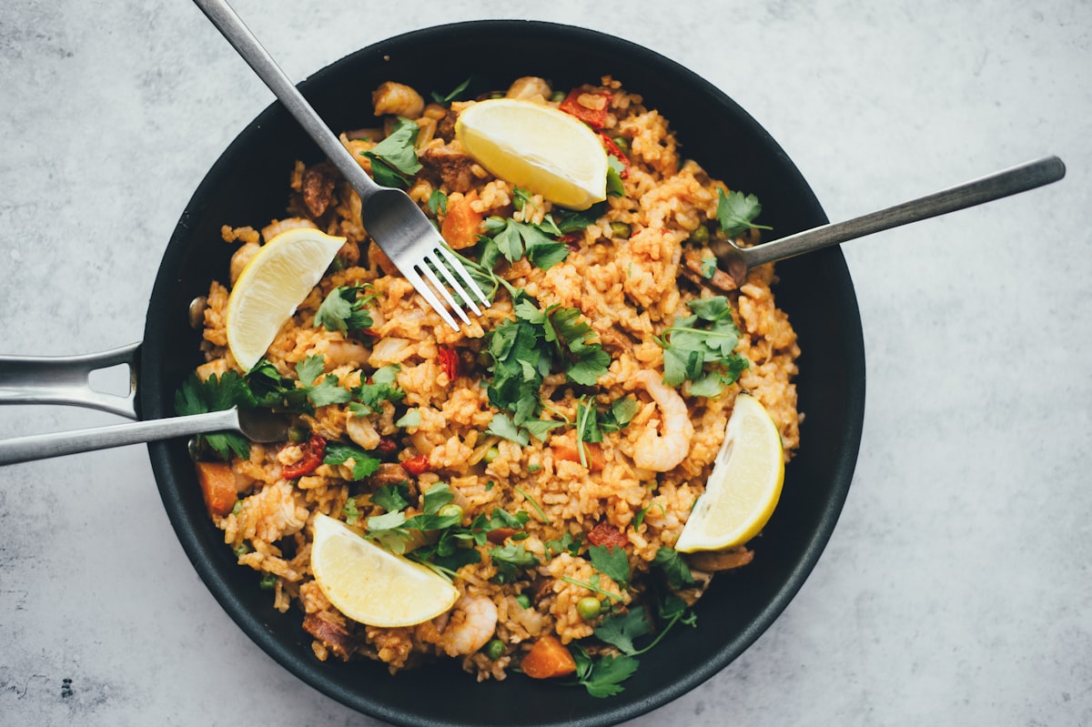 Stir-fried rice bowl with shrimp, vegetables, and fresh herbs