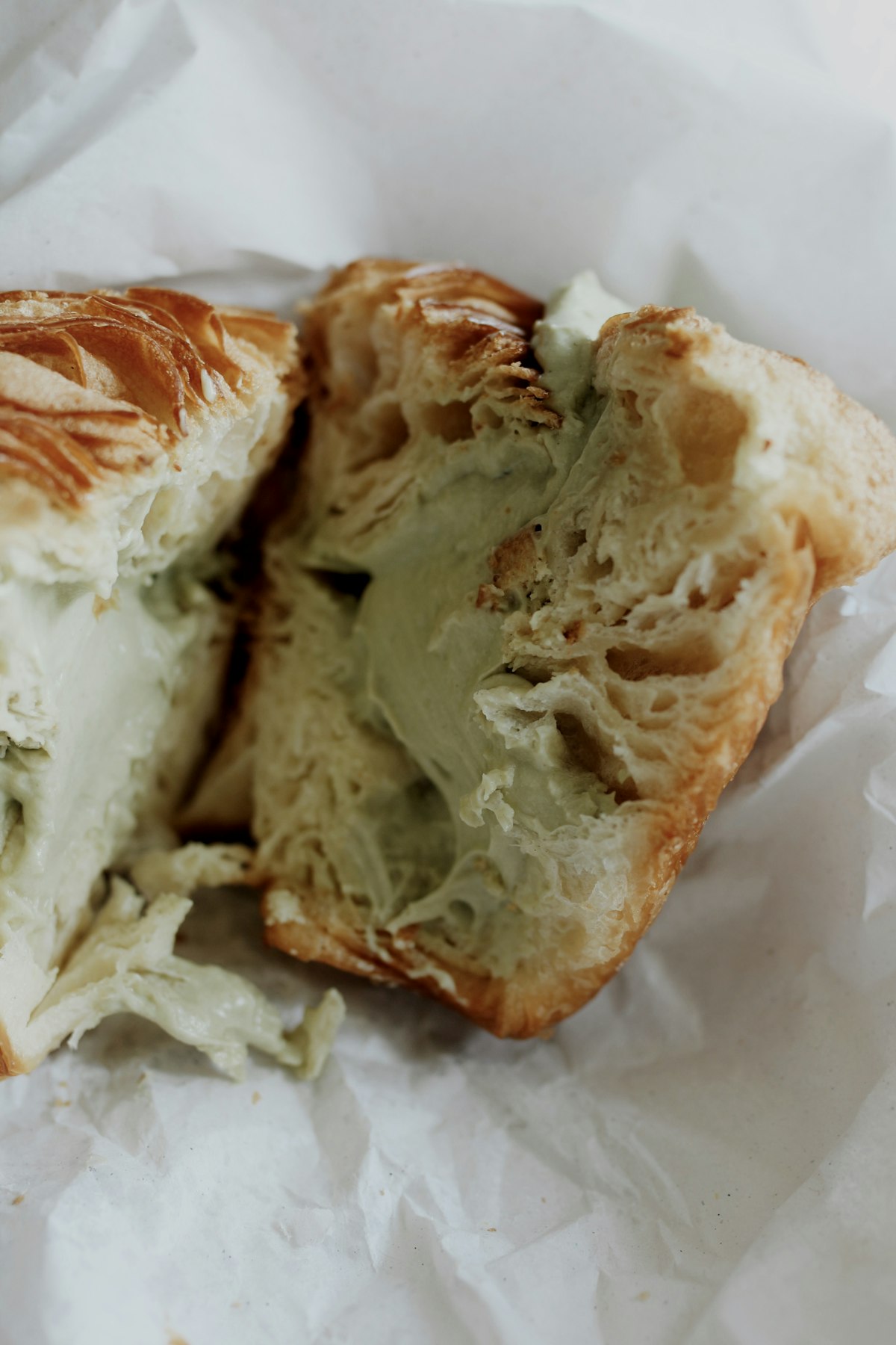 Pistachio cream-filled croissant on parchment paper