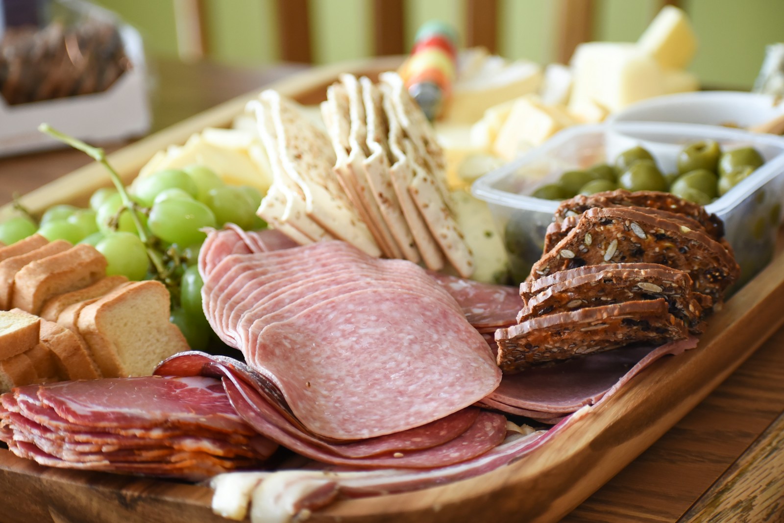 A beautifully arranged seacuterie board with crackers, spreads, and accompaniments