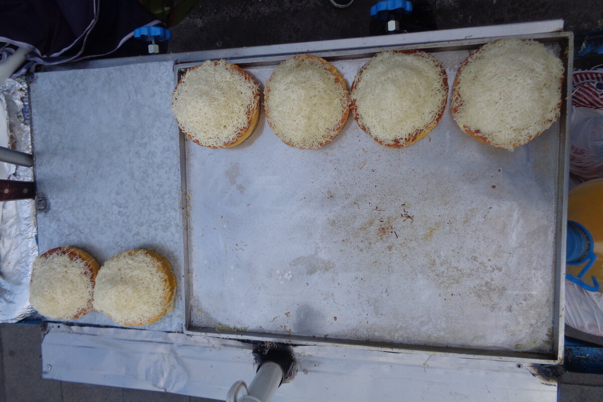 Venezuelan arepas street food on a grill, six arepas ready to eat